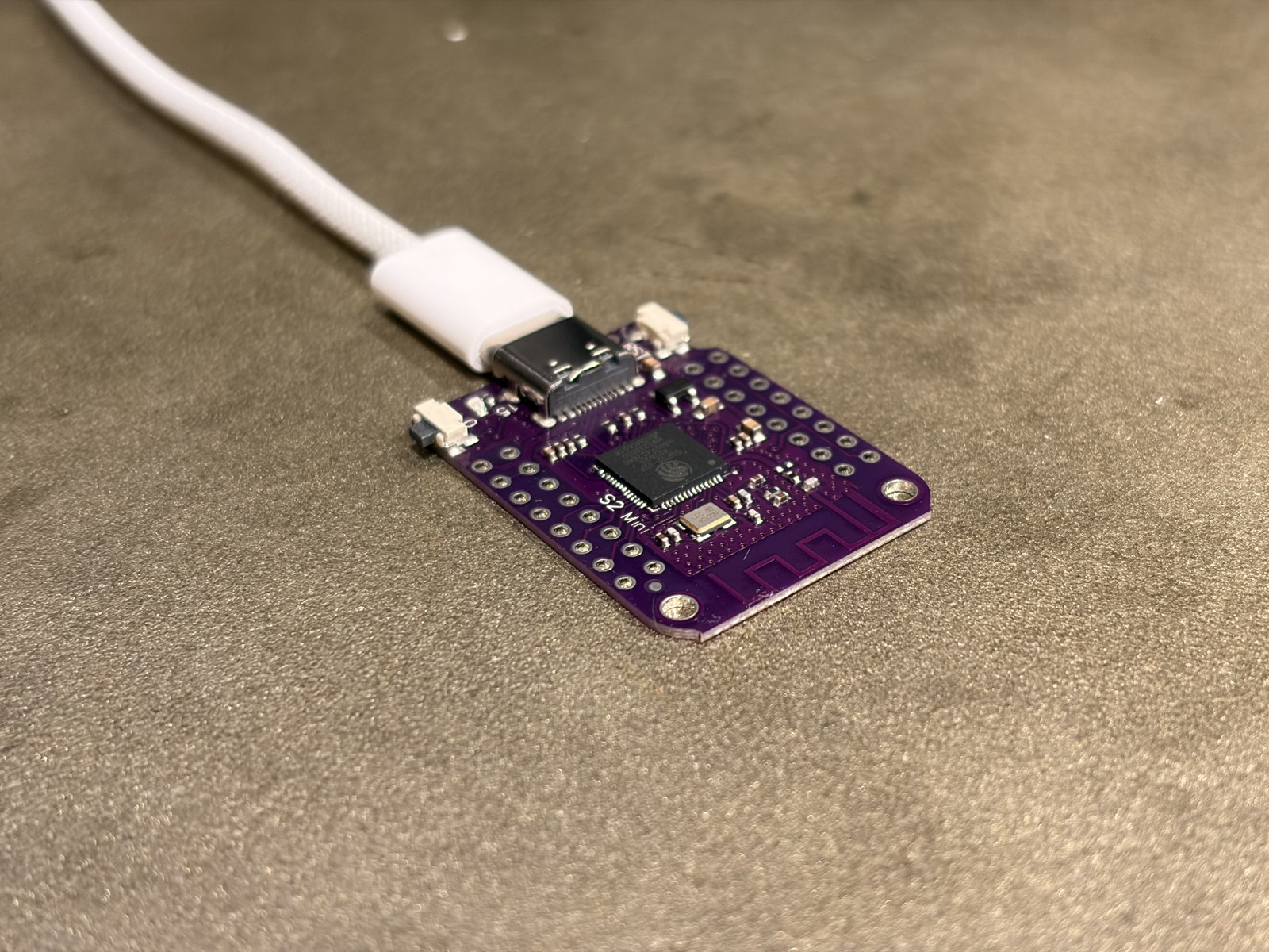 The receiver: a small purple ESP32-S2 board with native USB.