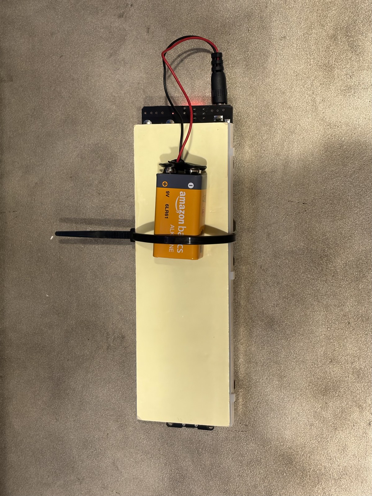 Back of the wireless remote with a 9V battery zip-tied on to make it cordless.